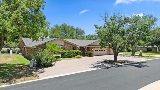 618 Hi Stirrup, Horseshoe Bay, TX 78657 - obstructed view of property with a garage, driveway, a front yard, and brick siding