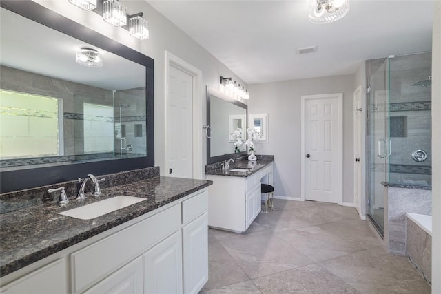 3437 Mulberry Creek Dr, Austin, TX 78732 - bathroom with a shower stall, two vanities, baseboards, and a tub to relax in