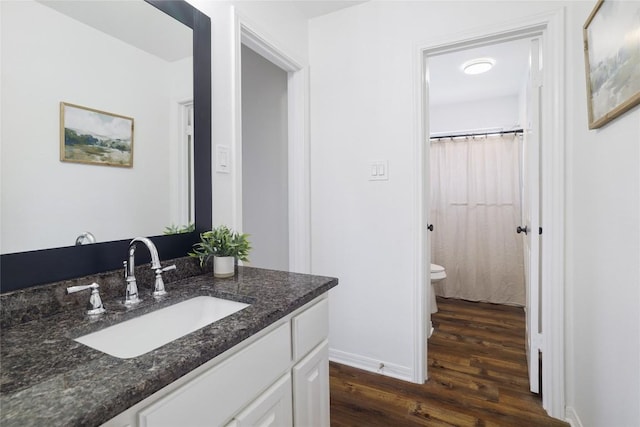 3437 Mulberry Creek Dr, Austin, TX 78732 - full bath with vanity, wood finished floors, toilet, and baseboards