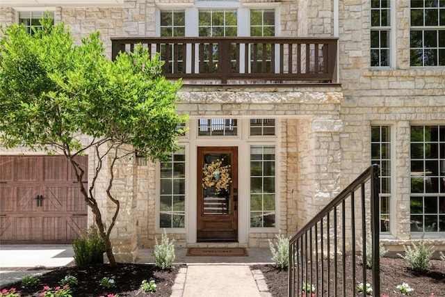 3437 Mulberry Creek Dr, Austin, TX 78732 - property entrance with a balcony and stone siding