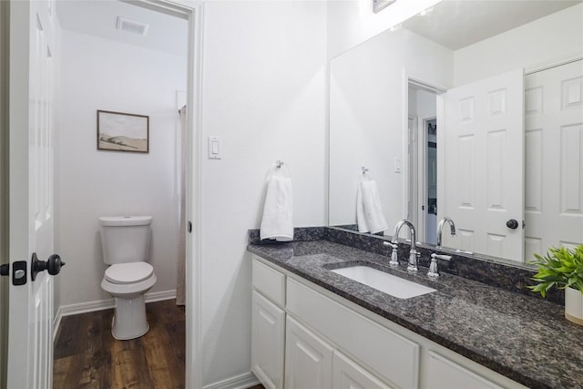 3437 Mulberry Creek Dr, Austin, TX 78732 - bathroom featuring vanity, wood finished floors, toilet, and baseboards