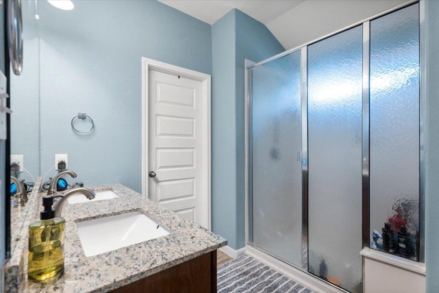 2313 Jake Pickle Pass, Leander, TX 78641 - bathroom with double vanity and a shower stall