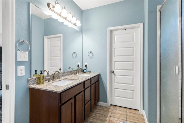 2313 Jake Pickle Pass, Leander, TX 78641 - full bathroom with double vanity and tile patterned flooring