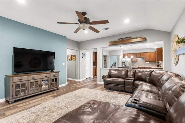 2313 Jake Pickle Pass, Leander, TX 78641 - living area featuring a ceiling fan, wood finished floors, vaulted ceiling, and recessed lighting
