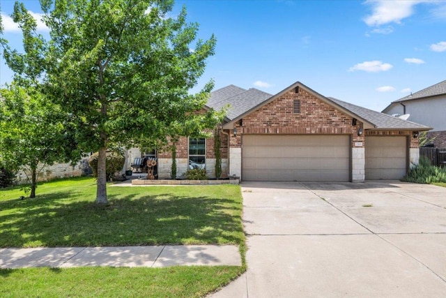 2313 Jake Pickle Pass, Leander, TX 78641 - view of front of property featuring an attached garage, brick siding, driveway, a front lawn, and a shingled roof