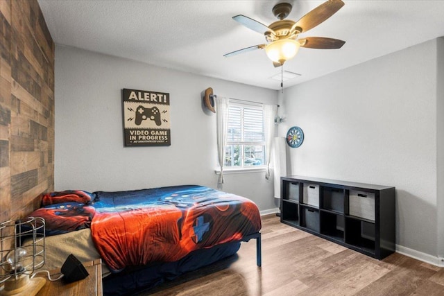 2313 Jake Pickle Pass, Leander, TX 78641 - bedroom with wood finished floors and a ceiling fan