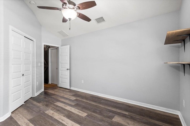 2313 Jake Pickle Pass, Leander, TX 78641 - unfurnished bedroom with dark wood-type flooring, a closet, and a ceiling fan