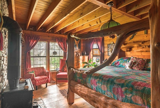 0000 Oakwood Loop, San Marcos, TX 78666 - bedroom with a wood stove, hardwood / wood-style flooring, and wooden walls