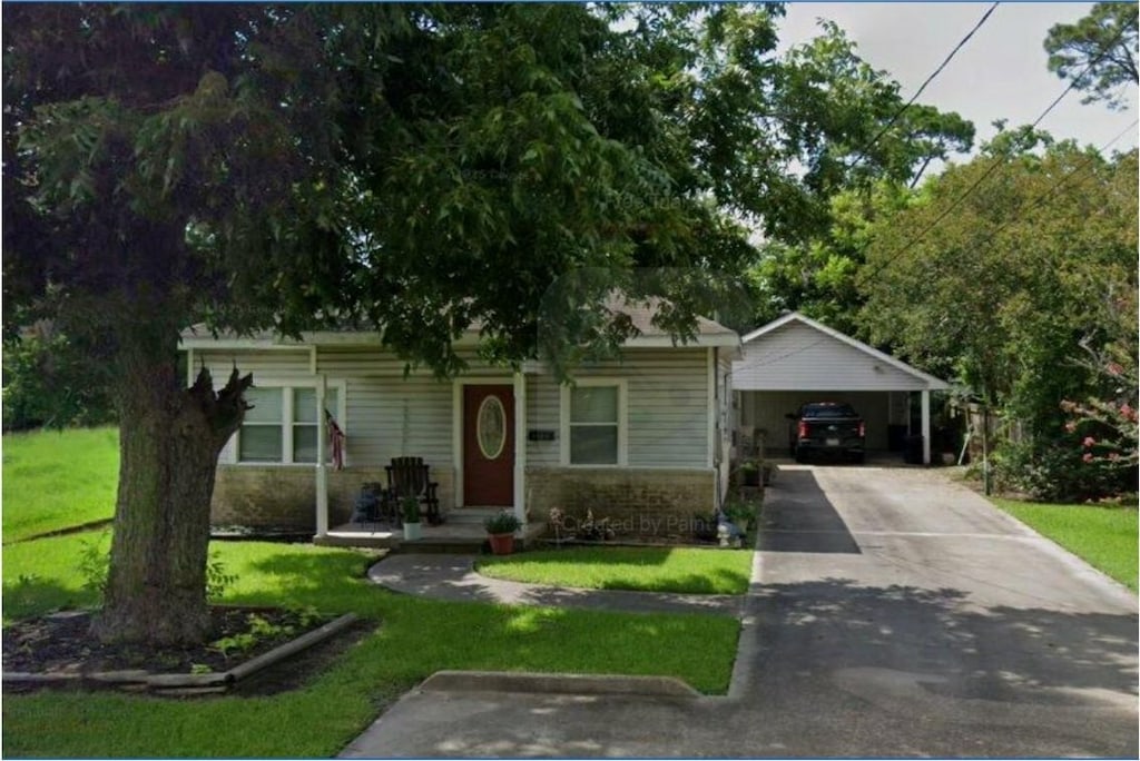 2126 11th St, Port Neches, TX 77651 - view of front of home with a front lawn and driveway