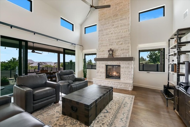 416 Kayak Way Unit 1, Austin, TX 78738 - living room with high vaulted ceiling, a large fireplace, wood finished floors, and plenty of natural light