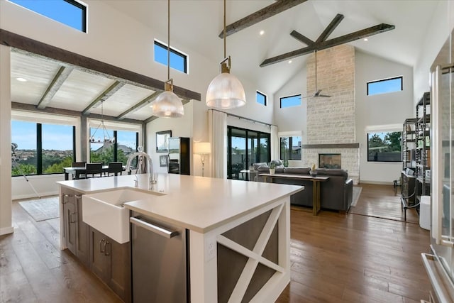 416 Kayak Way Unit 1, Austin, TX 78738 - kitchen with beam ceiling, high vaulted ceiling, stainless steel appliances, ceiling fan, and hanging light fixtures