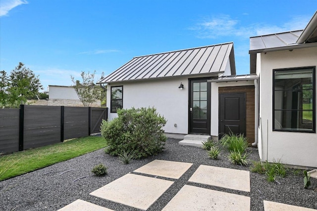 416 Kayak Way Unit 1, Austin, TX 78738 - property entrance featuring a standing seam roof, stucco siding, and metal roof
