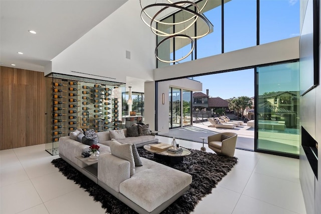 204 Wennmohs Pl, Horseshoe Bay, TX 78657 - tiled living area featuring wood walls, a high ceiling, and recessed lighting