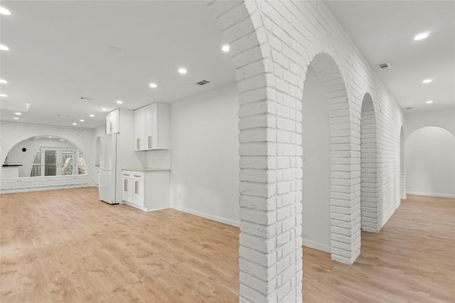 4202 N Hills Dr, Austin, TX 78731 - hallway with arched walkways, light wood finished floors, and recessed lighting