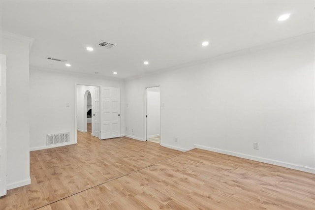 4202 N Hills Dr, Austin, TX 78731 - spare room featuring arched walkways, recessed lighting, light wood-style floors, and ornamental molding