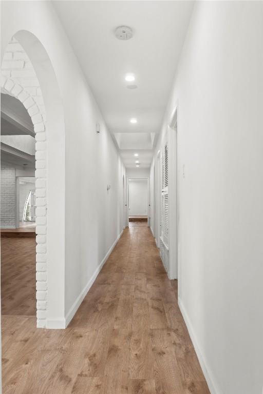 4202 N Hills Dr, Austin, TX 78731 - hallway with wood finished floors, recessed lighting, and arched walkways