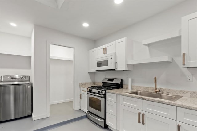 4202 N Hills Dr, Austin, TX 78731 - kitchen featuring open shelves, washer / dryer, stainless steel range with gas stovetop, white microwave, and white cabinets