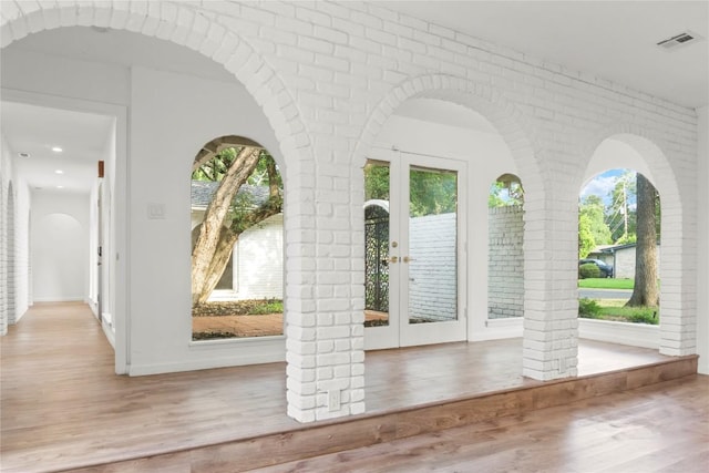 4202 N Hills Dr, Austin, TX 78731 - foyer featuring plenty of natural light, wood finished floors, brick wall, recessed lighting, and french doors