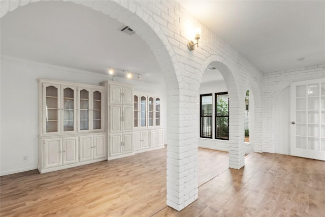 4202 N Hills Dr, Austin, TX 78731 - empty room featuring brick wall and light wood finished floors