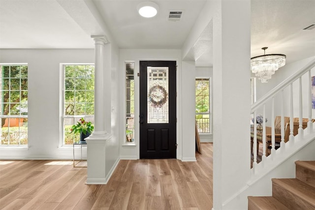 220 Grafton Ln, Austin, TX 78737 - foyer entrance featuring ornate columns, light wood-style flooring, stairs, and plenty of natural light