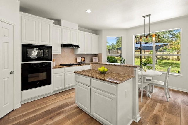 220 Grafton Ln, Austin, TX 78737 - kitchen with black appliances, under cabinet range hood, healthy amount of natural light, backsplash, and recessed lighting