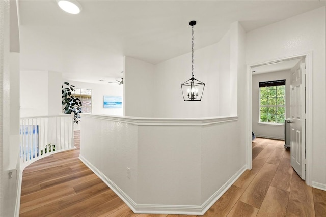 220 Grafton Ln, Austin, TX 78737 - corridor with wood finished floors, baseboards, and a chandelier