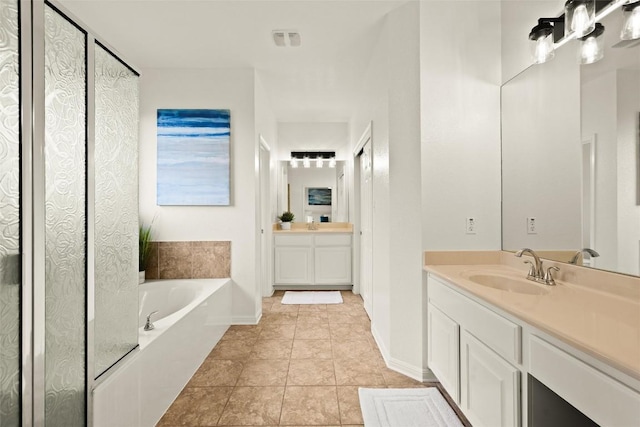 220 Grafton Ln, Austin, TX 78737 - full bathroom featuring a garden tub, two vanities, tile patterned floors, and baseboards