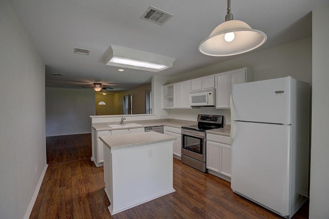 77 Jan Ln, Georgetown, TX 78626 - kitchen with appliances with stainless steel finishes, a peninsula, open shelves, and white cabinetry