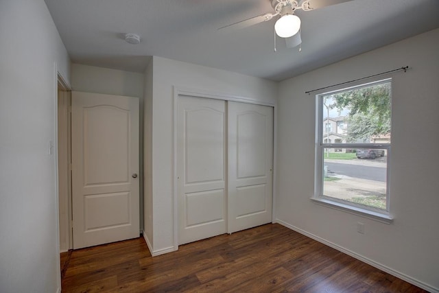 77 Jan Ln, Georgetown, TX 78626 - unfurnished bedroom with a closet, dark wood-style flooring, and a ceiling fan