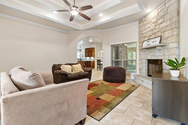 2034 Falling Leaf Ln, Harker Heights, TX 76548 - living room with arched walkways, ornamental molding, ceiling fan, a raised ceiling, and light tile patterned floors