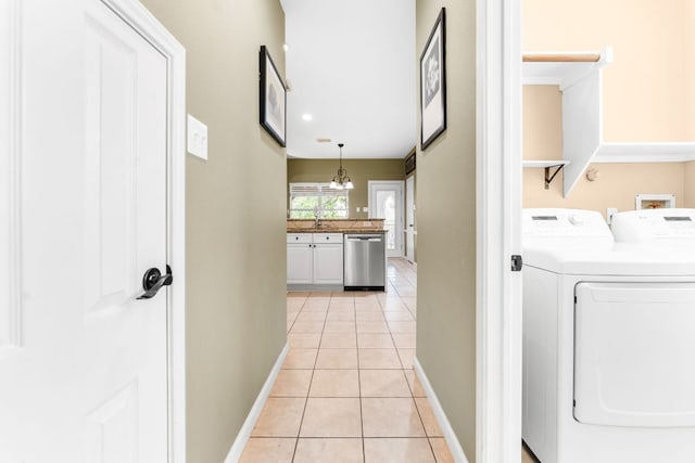 15150 Galena Dr, Austin, TX 78717 - laundry room with baseboards, light tile patterned flooring, separate washer and dryer, and a chandelier
