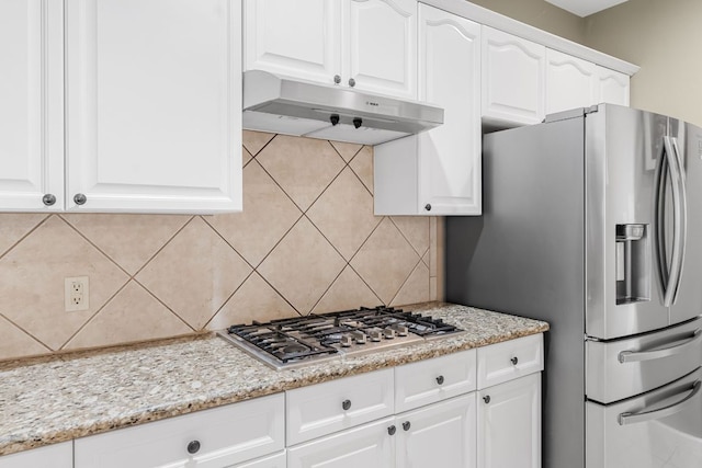 15150 Galena Dr, Austin, TX 78717 - kitchen featuring under cabinet range hood, appliances with stainless steel finishes, decorative backsplash, white cabinetry, and light stone countertops