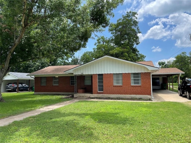 207 N 1st St, Thorndale, TX 76577 - ranch-style house with a carport, a front lawn, brick siding, and driveway