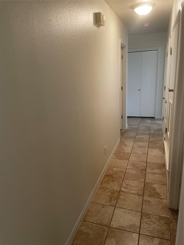 207 N 1st St, Thorndale, TX 76577 - corridor with baseboards and light tile patterned floors