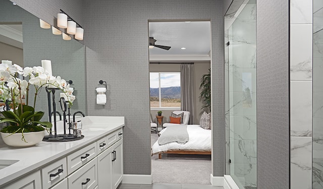 20408 Stelfox St, Manor, TX 78653 - ensuite bathroom featuring ornamental molding, double vanity, ceiling fan, a walk in shower, and a mountain view