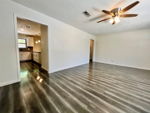 3500 Loyola Ln, Austin, TX 78723 - spare room featuring ceiling fan, dark wood-type flooring, and baseboards