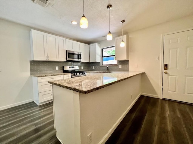 3500 Loyola Ln, Austin, TX 78723 - kitchen featuring stainless steel appliances, baseboards, backsplash, white cabinets, and a textured ceiling