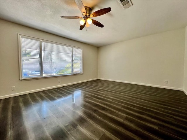 3500 Loyola Ln, Austin, TX 78723 - unfurnished room with dark wood-style floors, a ceiling fan, and baseboards