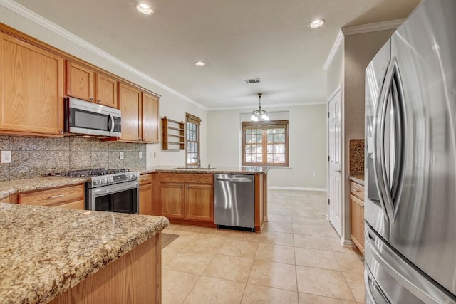 401 Texas Dr, Georgetown, TX 78633 - kitchen featuring appliances with stainless steel finishes, crown molding, a peninsula, tasteful backsplash, and a sink