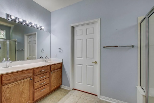 401 Texas Dr, Georgetown, TX 78633 - full bathroom with a stall shower, double vanity, tile patterned floors, and baseboards