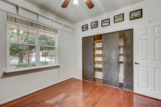 401 Texas Dr, Georgetown, TX 78633 - unfurnished bedroom with wood finished floors, a closet, and a ceiling fan
