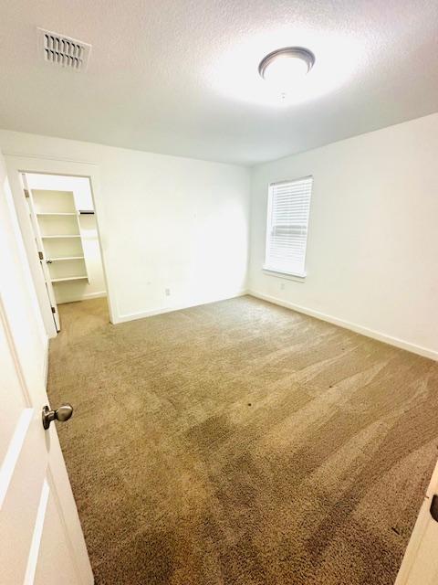 2376 Sawdust Dr, Georgetown, TX 78633 - carpeted spare room featuring a textured ceiling and baseboards