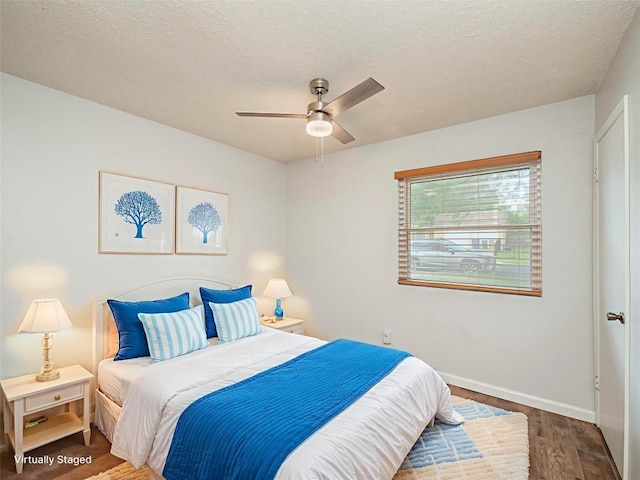 410 Blueberry Hl, Austin, TX 78745 - bedroom featuring wood finished floors, a textured ceiling, and a ceiling fan
