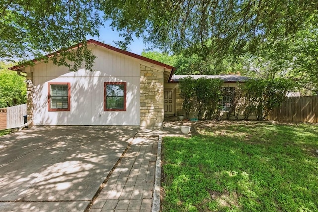 4802 Peach Grove Ct, Austin, TX 78744 - single story home with a patio and stone siding