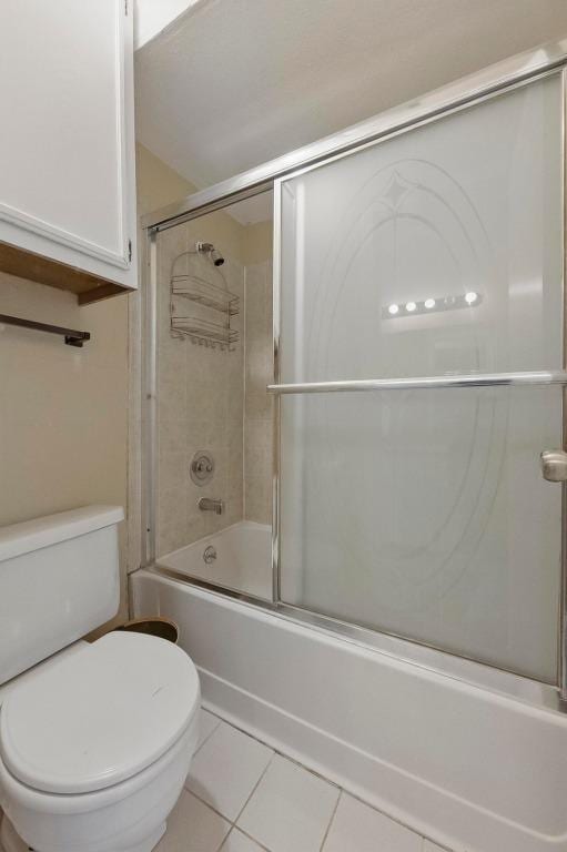 4802 Peach Grove Ct, Austin, TX 78744 - bathroom featuring tile patterned floors, toilet, and shower / bath combination with glass door