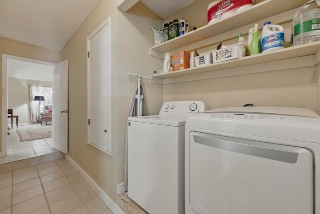 4802 Peach Grove Ct, Austin, TX 78744 - laundry room with washing machine and dryer, light tile patterned floors, and baseboards