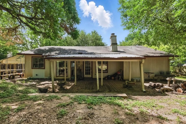 4802 Peach Grove Ct, Austin, TX 78744 - back of property with a chimney and a deck