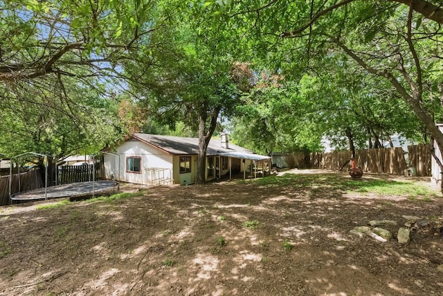 4802 Peach Grove Ct, Austin, TX 78744 - fenced backyard featuring a trampoline