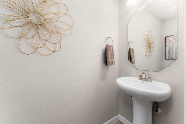 228 Wallops, Kyle, TX 78640 - bathroom featuring a sink and baseboards