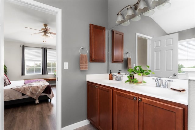 228 Wallops, Kyle, TX 78640 - ensuite bathroom with plenty of natural light, double vanity, a ceiling fan, baseboards, and lofted ceiling